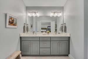 Bathroom featuring double vanity and ensuite bath