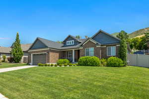 Craftsman inspired home with brick siding, a garage, concrete driveway, and covered porch