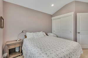 Bedroom with carpet, recessed lighting, a closet, and lofted ceiling