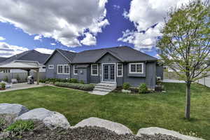 View of front facade with french doors, roof with shingles, a patio area, a gazebo, and entry steps