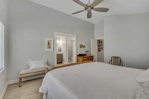 Bedroom featuring light carpet, a ceiling fan, and lofted ceiling