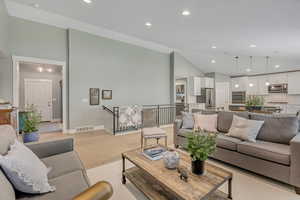 Living room featuring recessed lighting, light wood-style floors, and vaulted ceiling