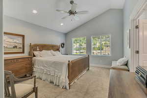 Bedroom with vaulted ceiling, light carpet, ceiling fan, and recessed lighting