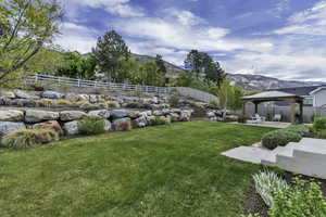 Fenced backyard featuring a gazebo, a patio, and a mountain view