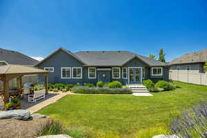 Rear view of house featuring french doors, a gazebo, and a shingled roof