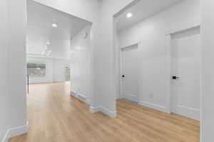 Corridor with recessed lighting and light wood finished floors
