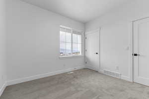 Unfurnished bedroom with baseboards and carpet flooring