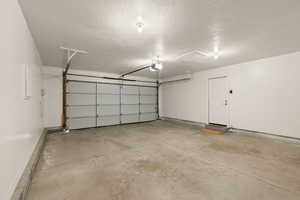 Garage with baseboards and a garage door opener