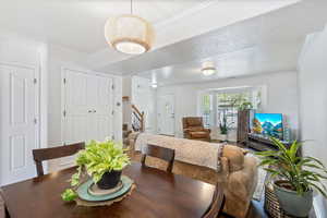 Dining space with ornamental molding and a textured ceiling