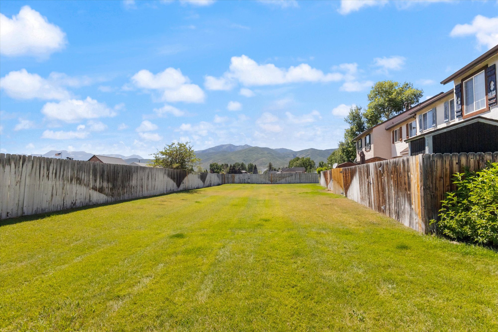 Fenced backyard with a mountain view