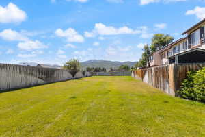 Fenced backyard with a mountain view