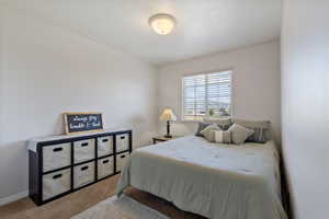 Bedroom featuring carpet and a textured ceiling