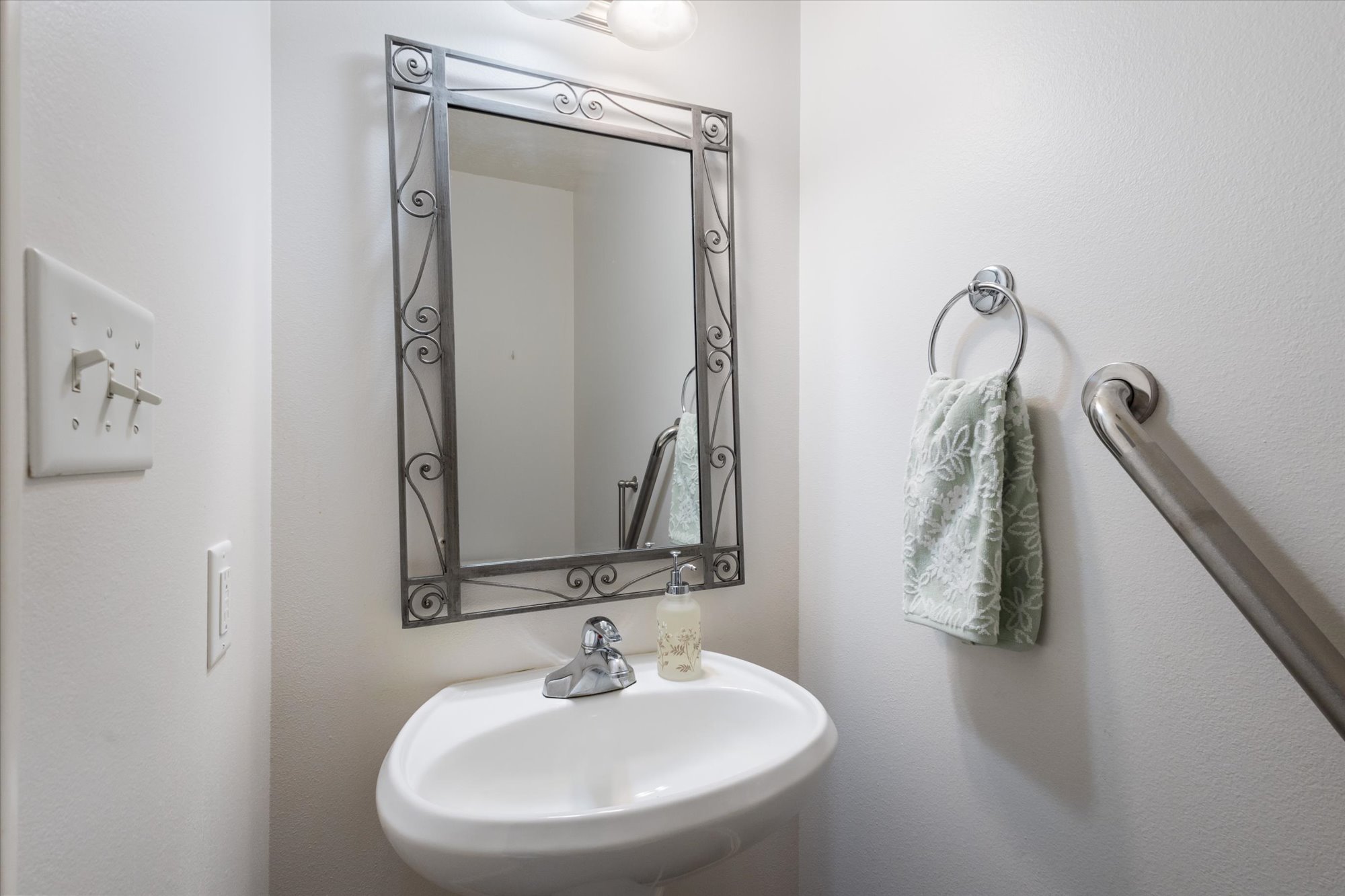 Bathroom featuring a sink and a textured wall