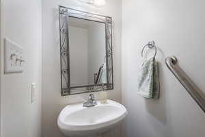 Bathroom featuring a sink and a textured wall