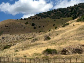 View of mountain backdrop featuring rural landscape