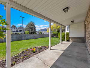 Fenced backyard with a patio