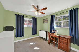 Office space featuring light carpet and ceiling fan
