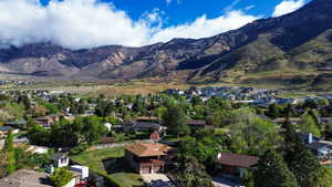 View of mountain backdrop featuring nearby suburban area