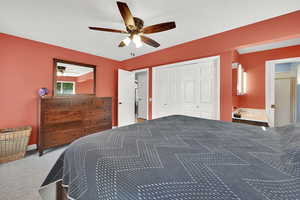 Bedroom with carpet flooring, a ceiling fan, and a closet