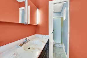 Full bath featuring vanity and a stall shower