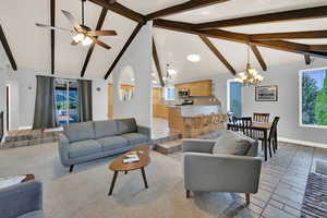 Living area featuring plenty of natural light, suspended lighting, and ceiling fan