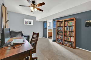 Office space featuring light colored carpet and ceiling fan