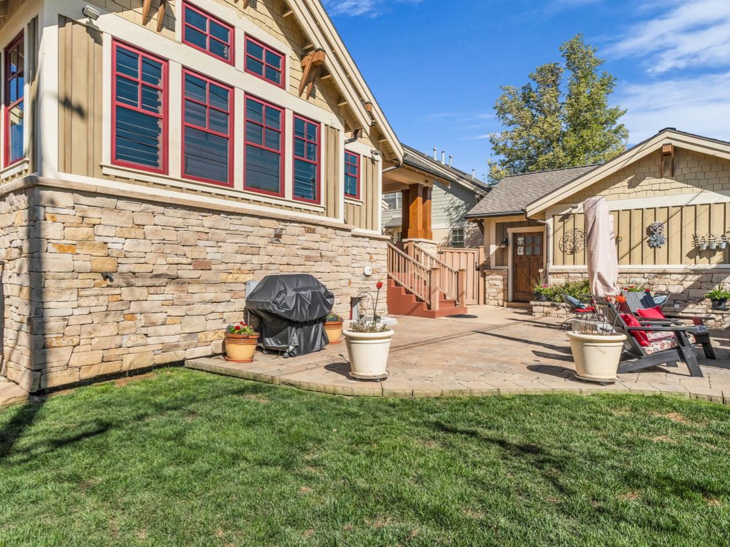 View of grassy yard featuring a patio area