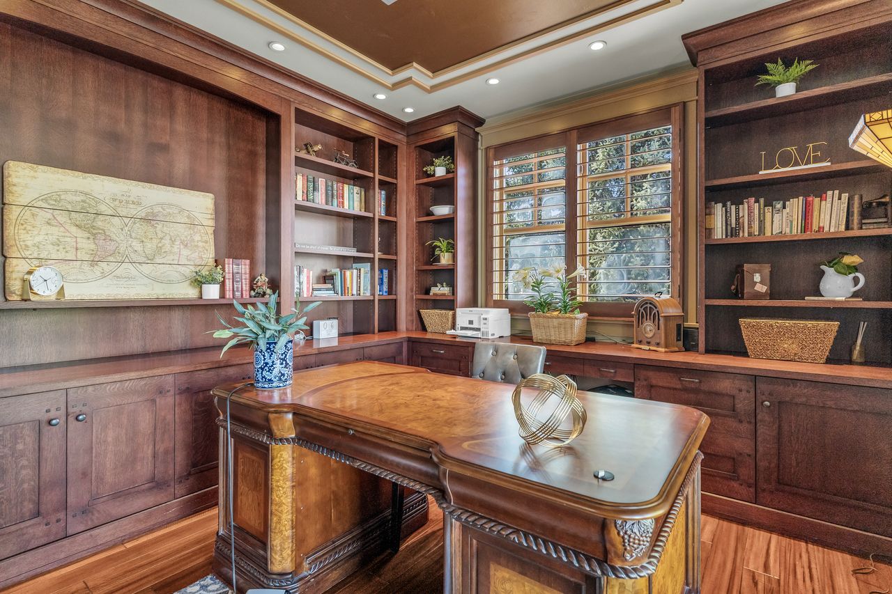 Office featuring built in features, ornamental molding, and light wood flooring