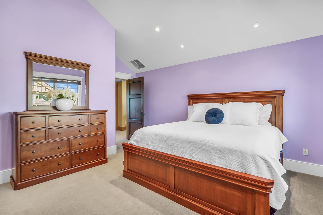 Bedroom with lofted ceiling, light carpet, and recessed lighting