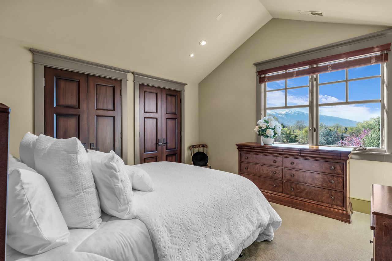 Bedroom with beautiful view, light carpet, and recessed lighting