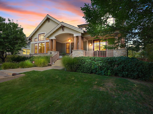 Craftsman house featuring a front lawn and stone siding
