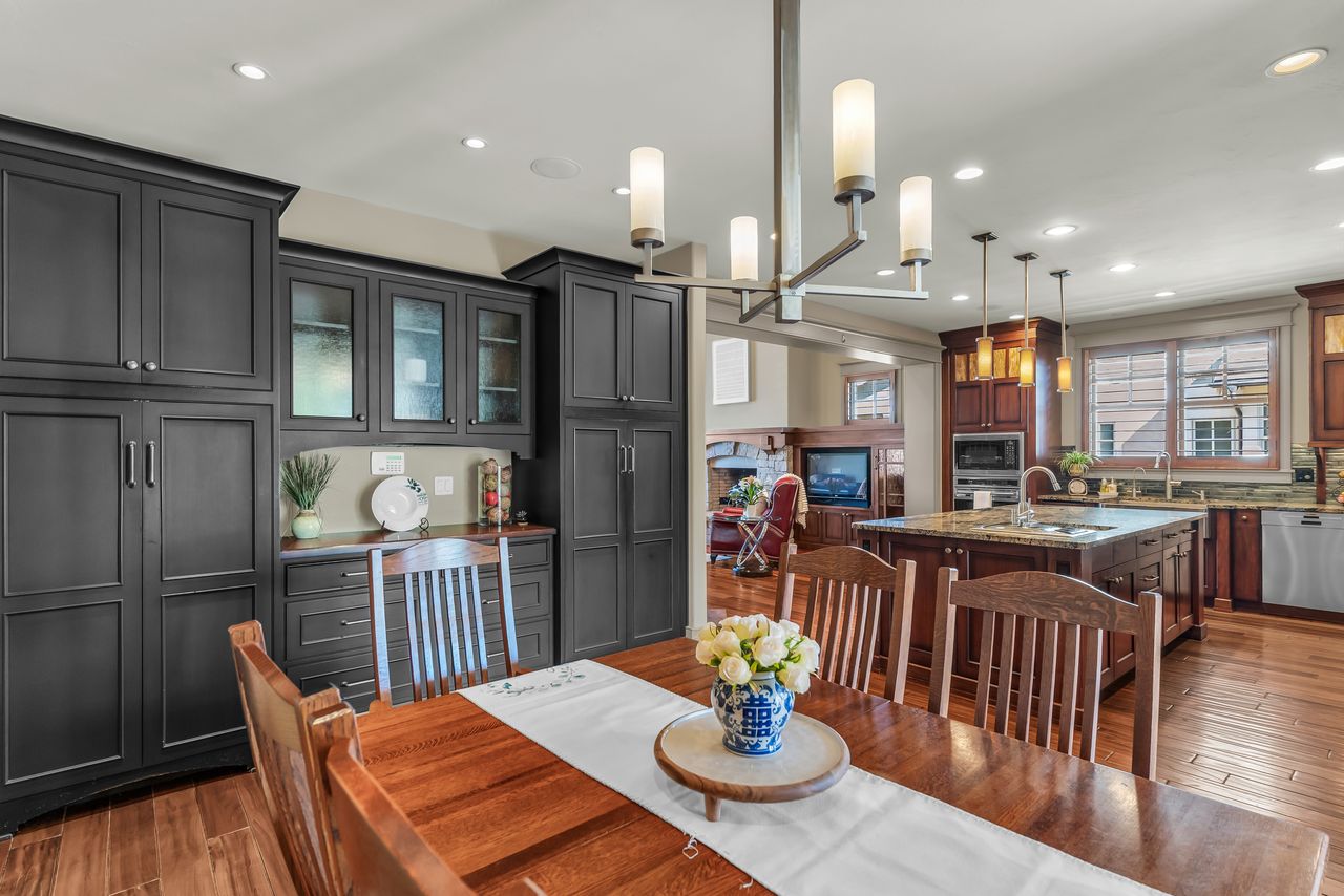 Dining room with dark wood finished floors and recessed lighting
