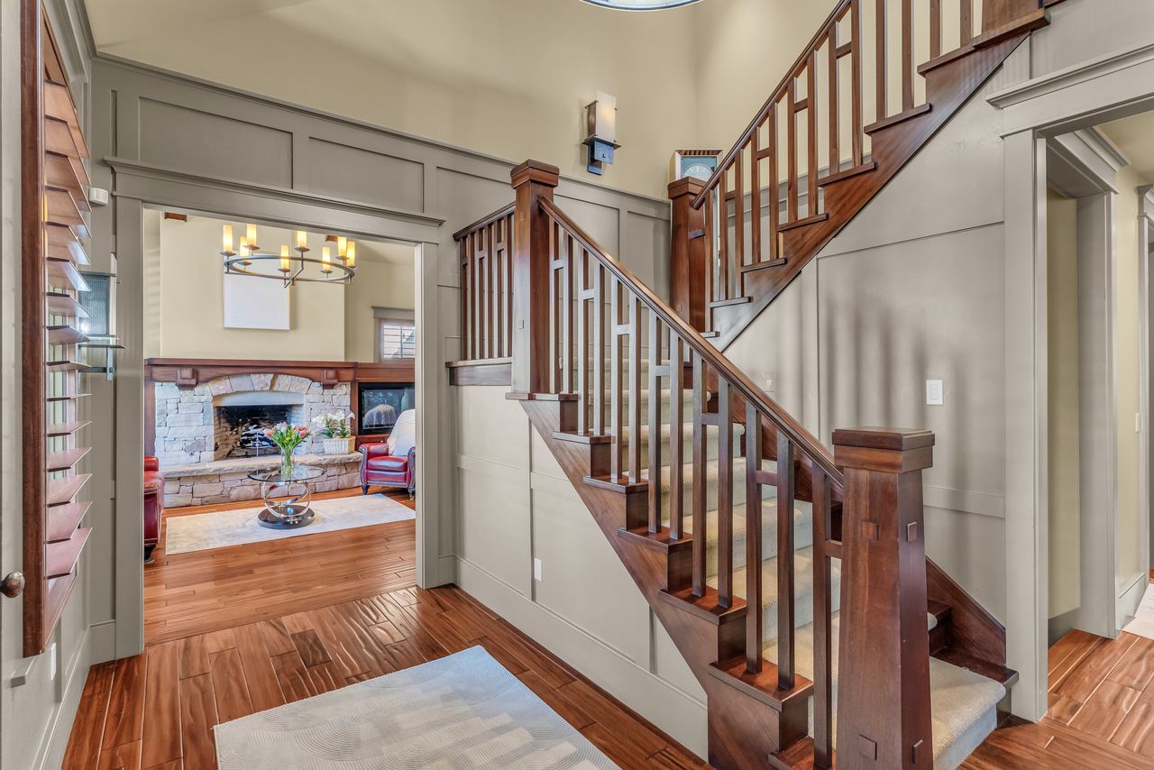 Foyer featuring a decorative wall, and wood stairway