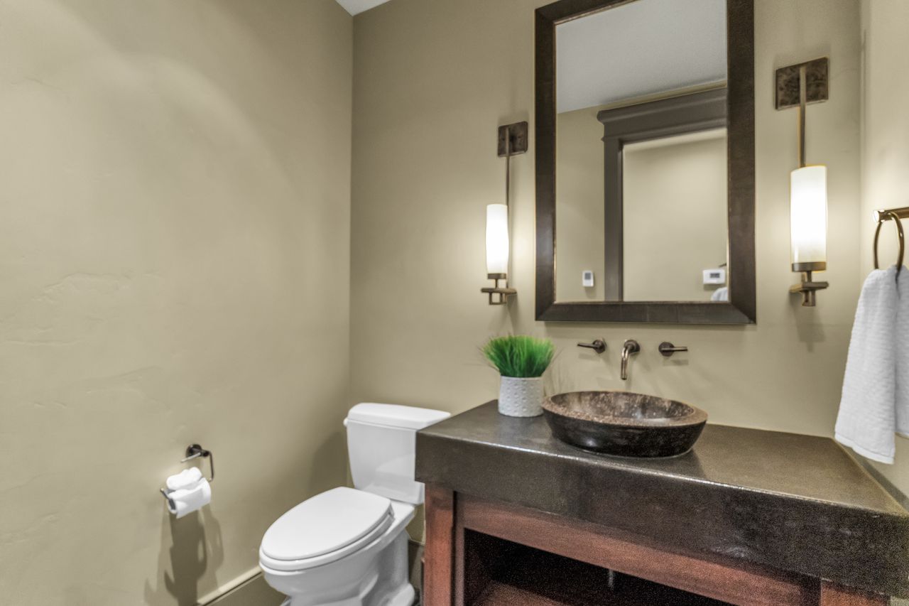 Half bathroom with toilet and vanity