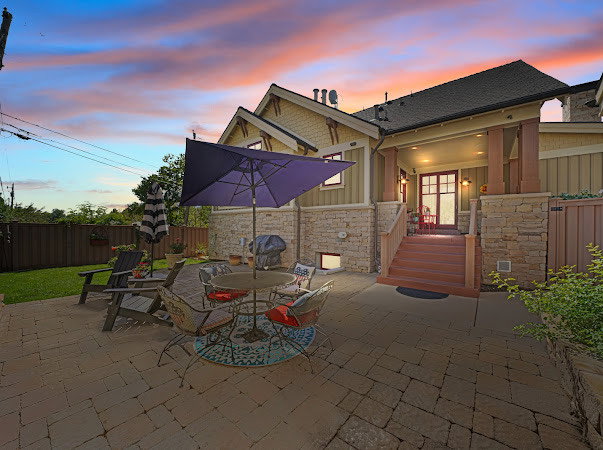Patio terrace at dusk with a fenced backyard, a patio area, and outdoor dining space