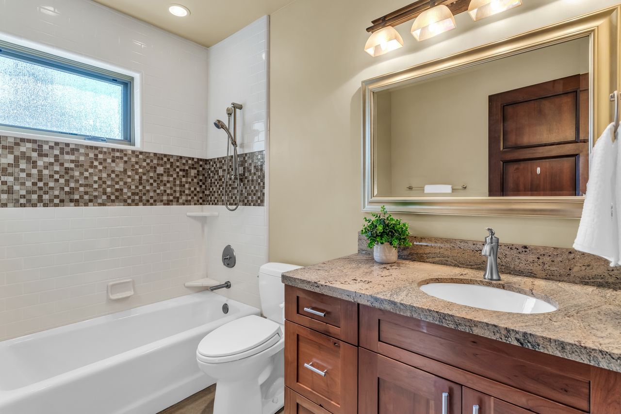 Bathroom with vanity and tiled bathing tub / shower combination