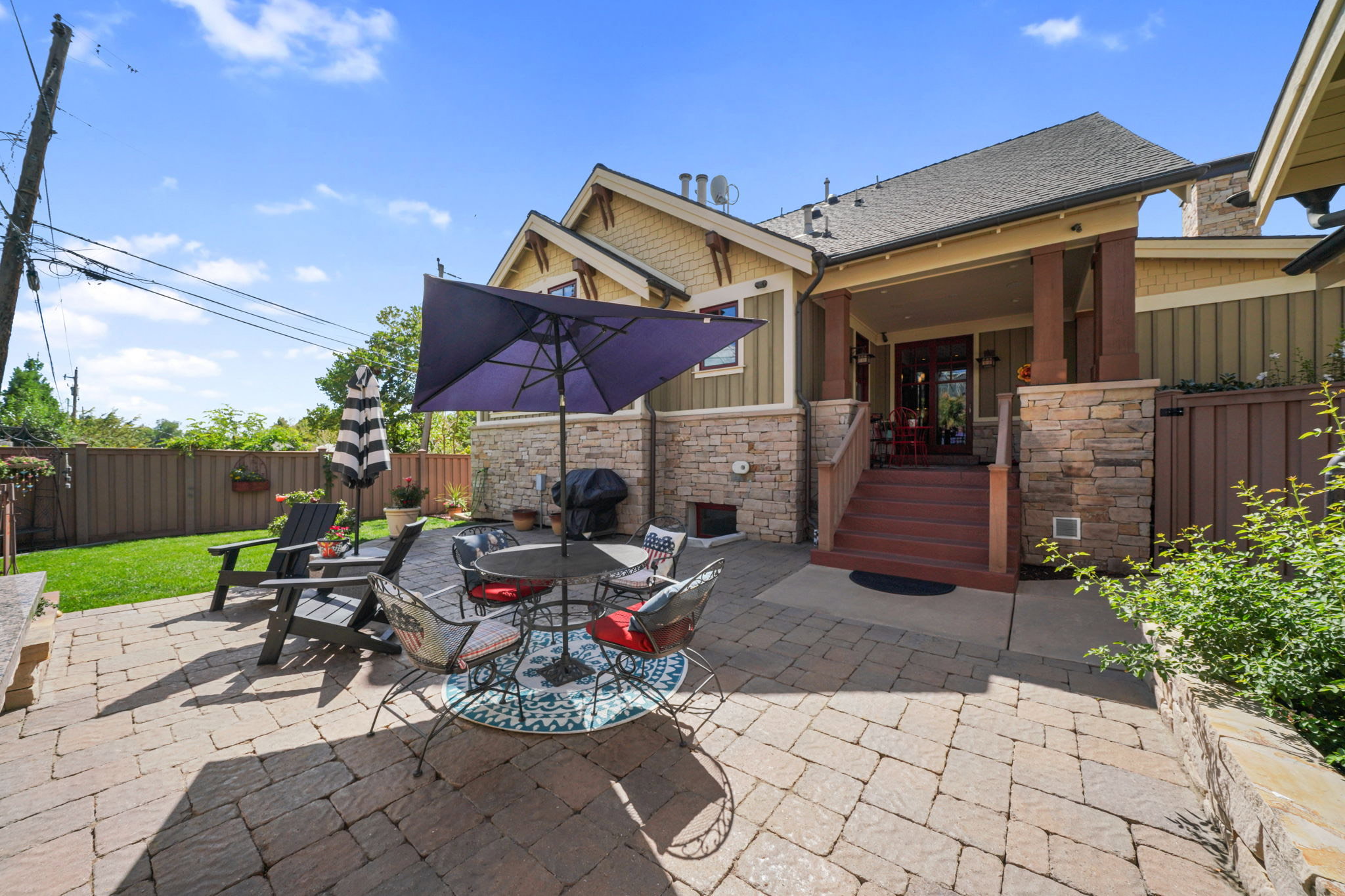 Fenced backyard featuring a patio, outdoor dining space, and area for grilling