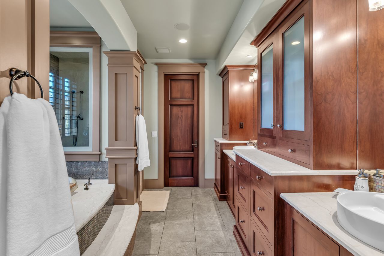 Primary bathroom with vanity, walk in shower, a soaking tub, and recessed lighting