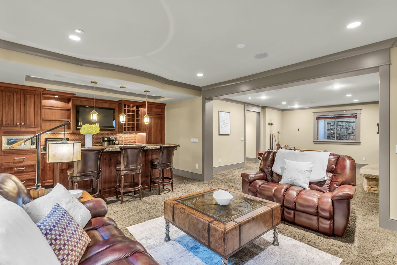 Living area with recessed lighting and wet bar