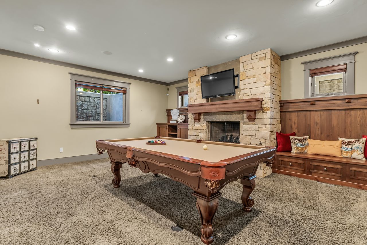 Recreation room with carpet flooring, a fireplace, billiards, ornamental molding, and recessed lighting