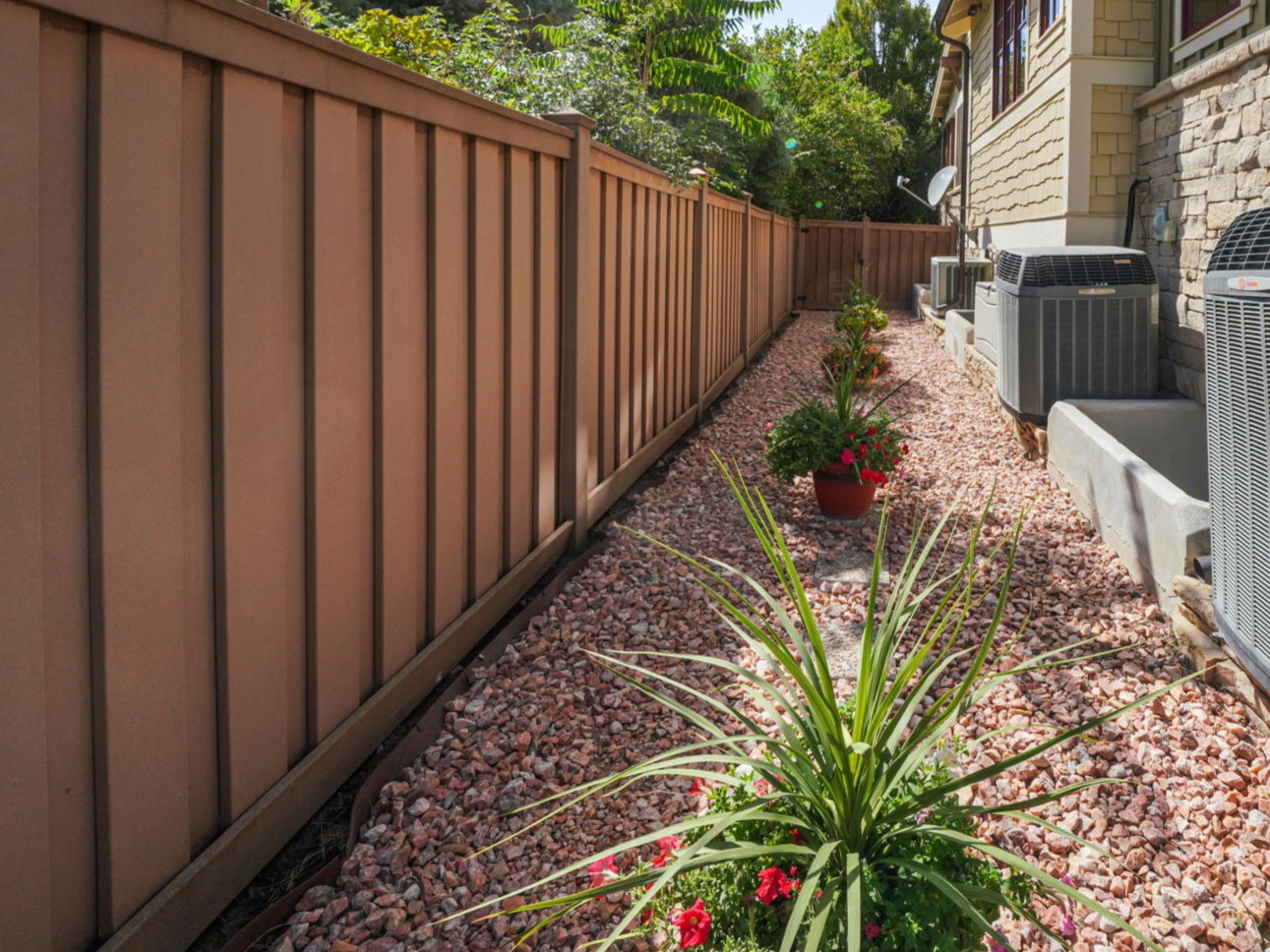 View of side yard and a fenced backyard