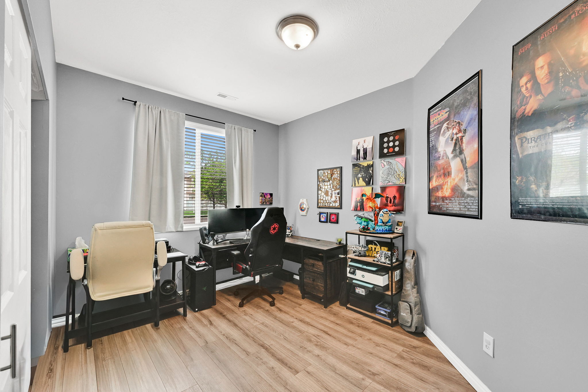 Office area with light wood-style flooring and baseboards