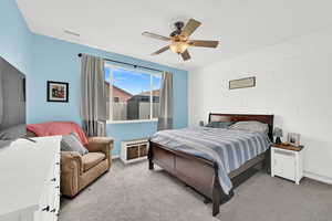 Bedroom featuring light carpet and ceiling fan
