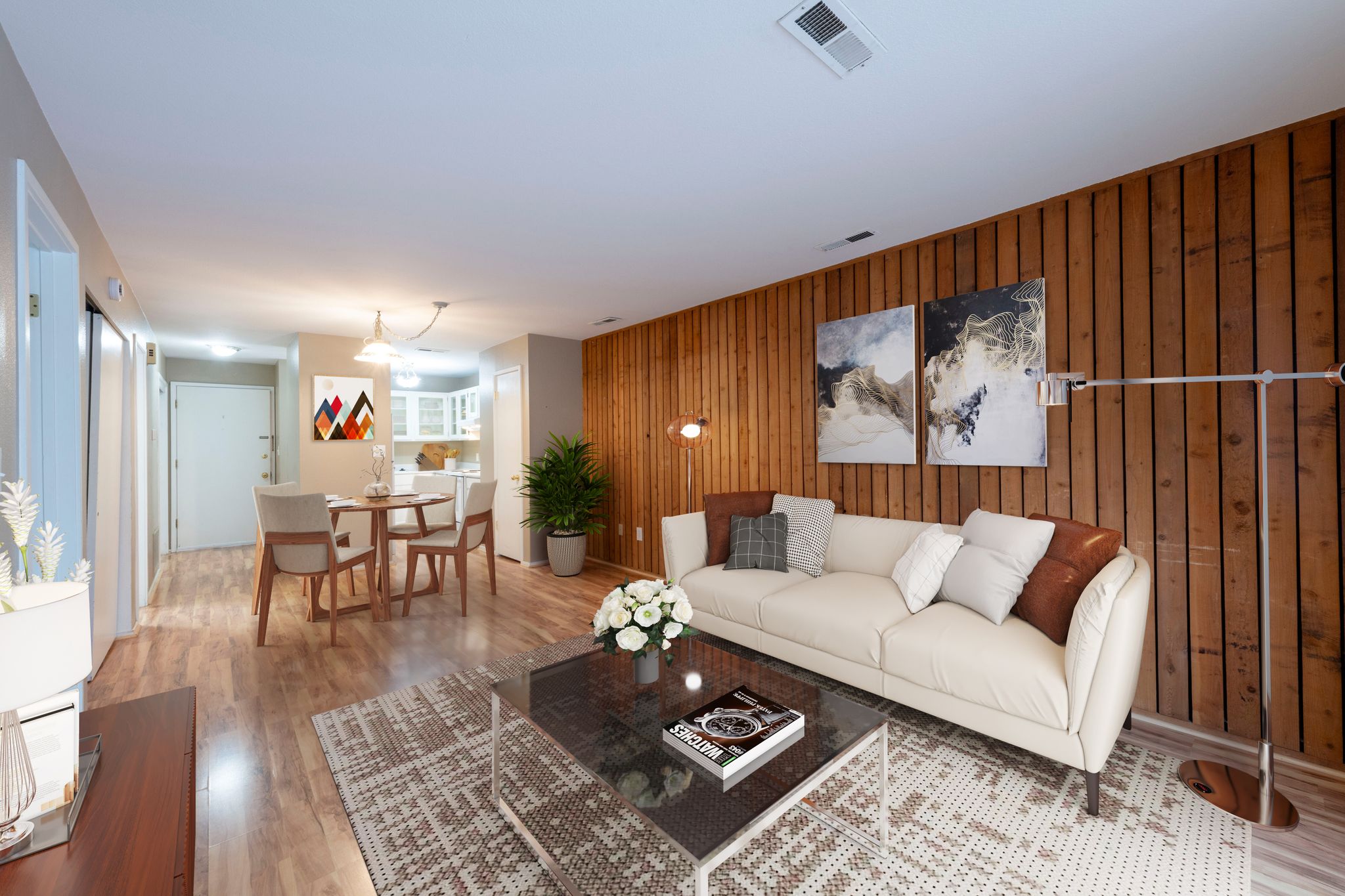 Living room with wood finished floors and wooden accents wall.
