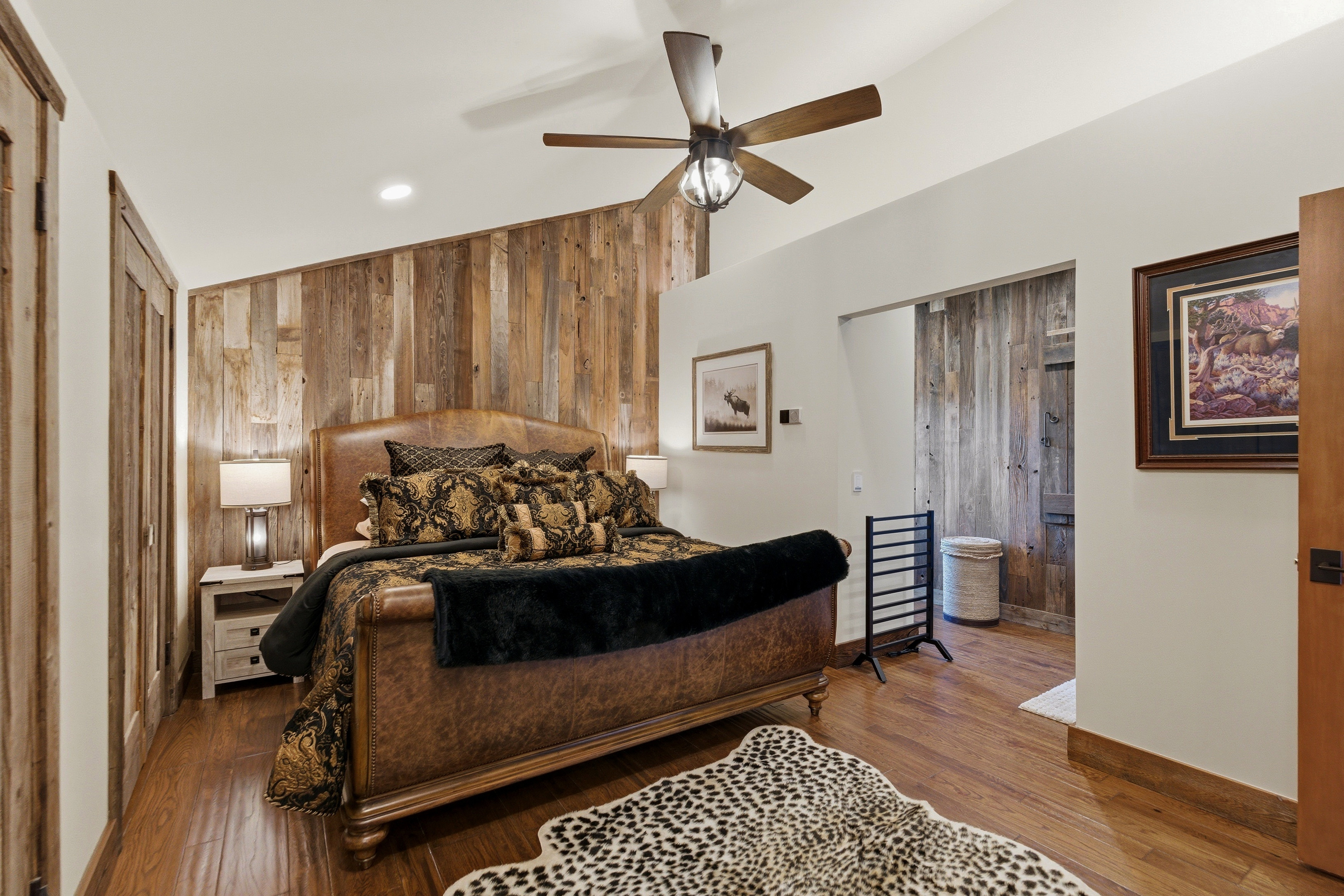 Bedroom featuring wooden walls, vaulted ceiling, ceiling fan, recessed lighting, and wood finished floors