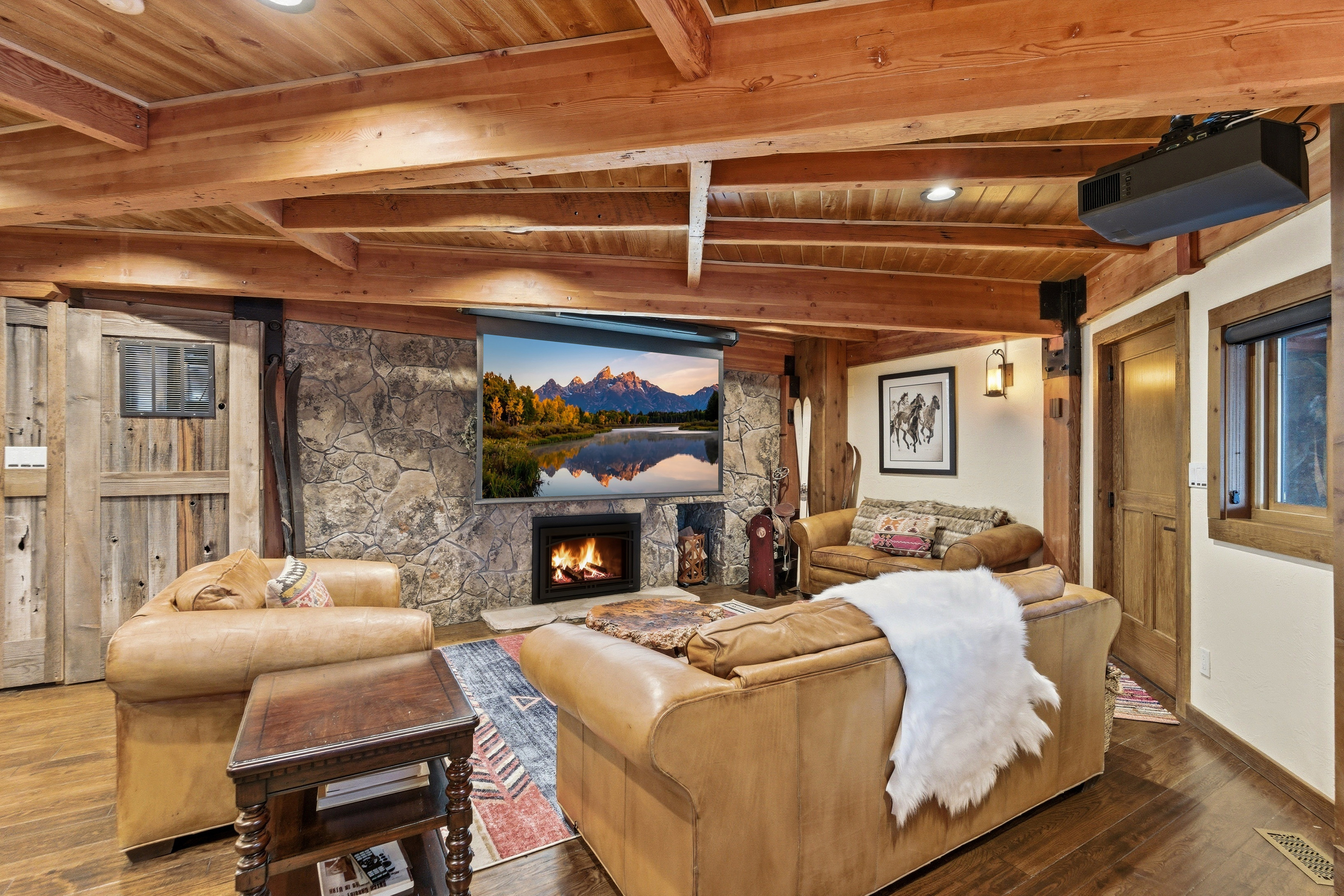 Home theater with a fireplace, a wooden ceiling with exposed beams, wood finished floors, and recessed lighting