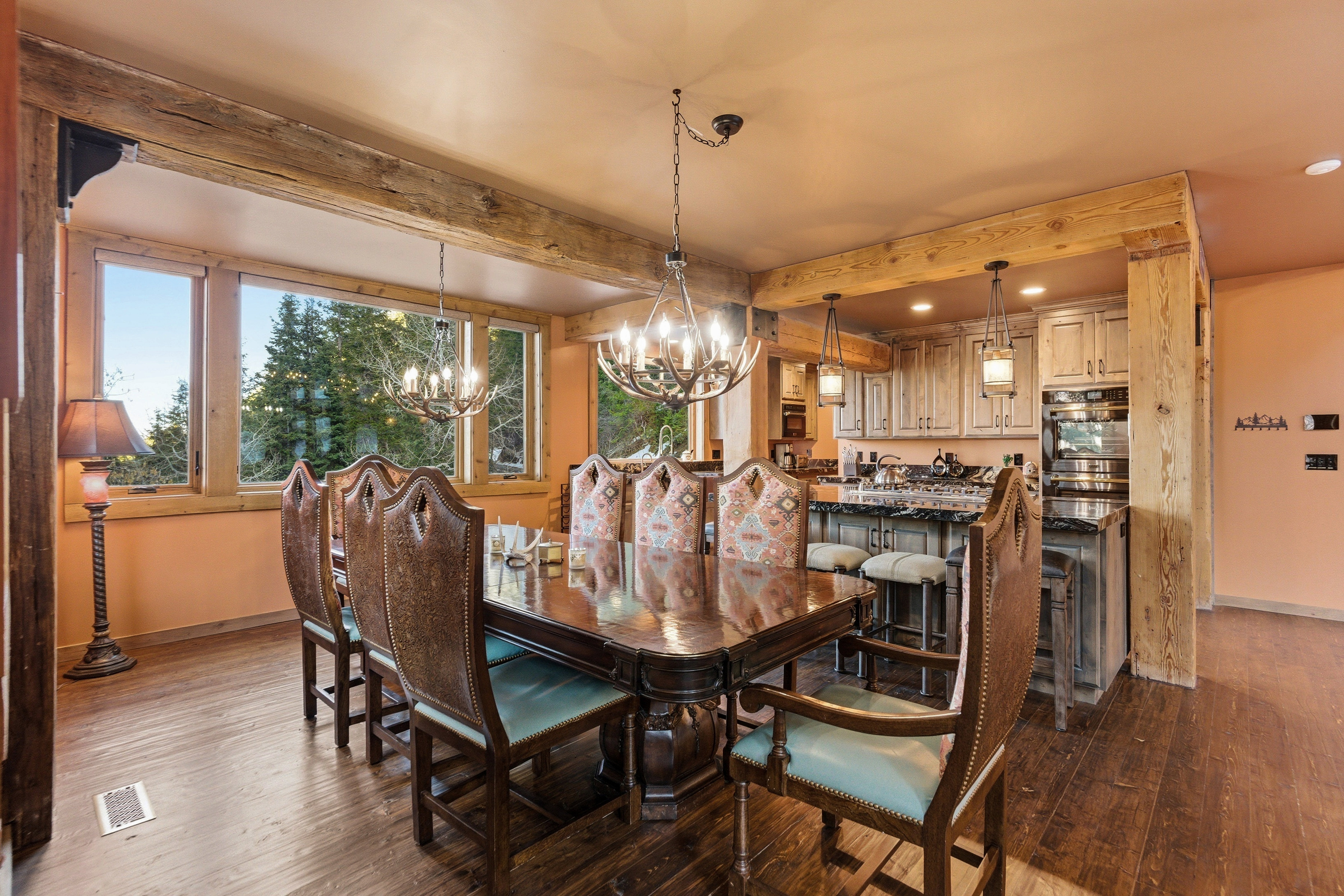 Dining room featuring dark wood-style floors, a chandelier, and beam ceiling