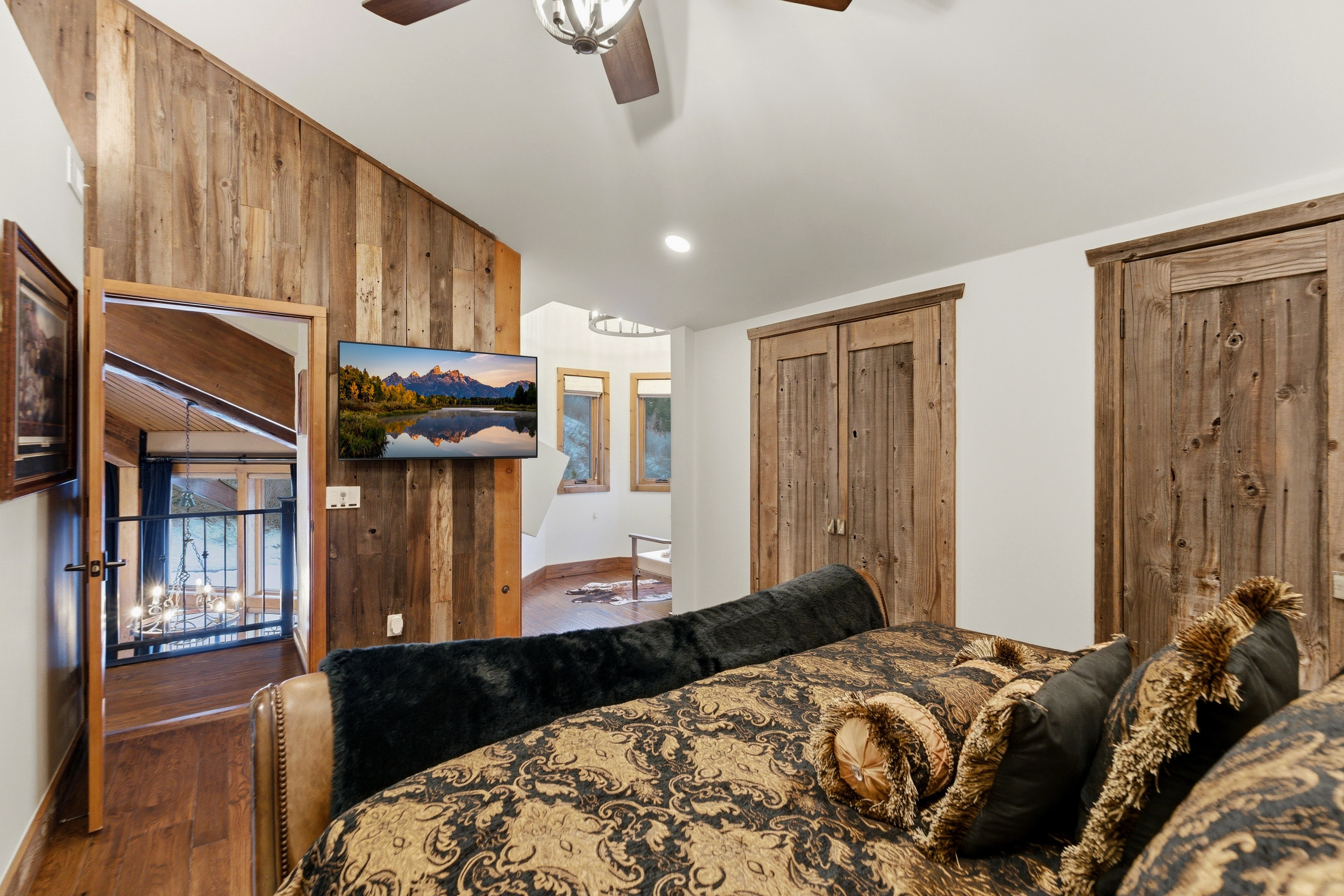 Bedroom featuring vaulted ceiling, wood finished floors, recessed lighting, and wood walls