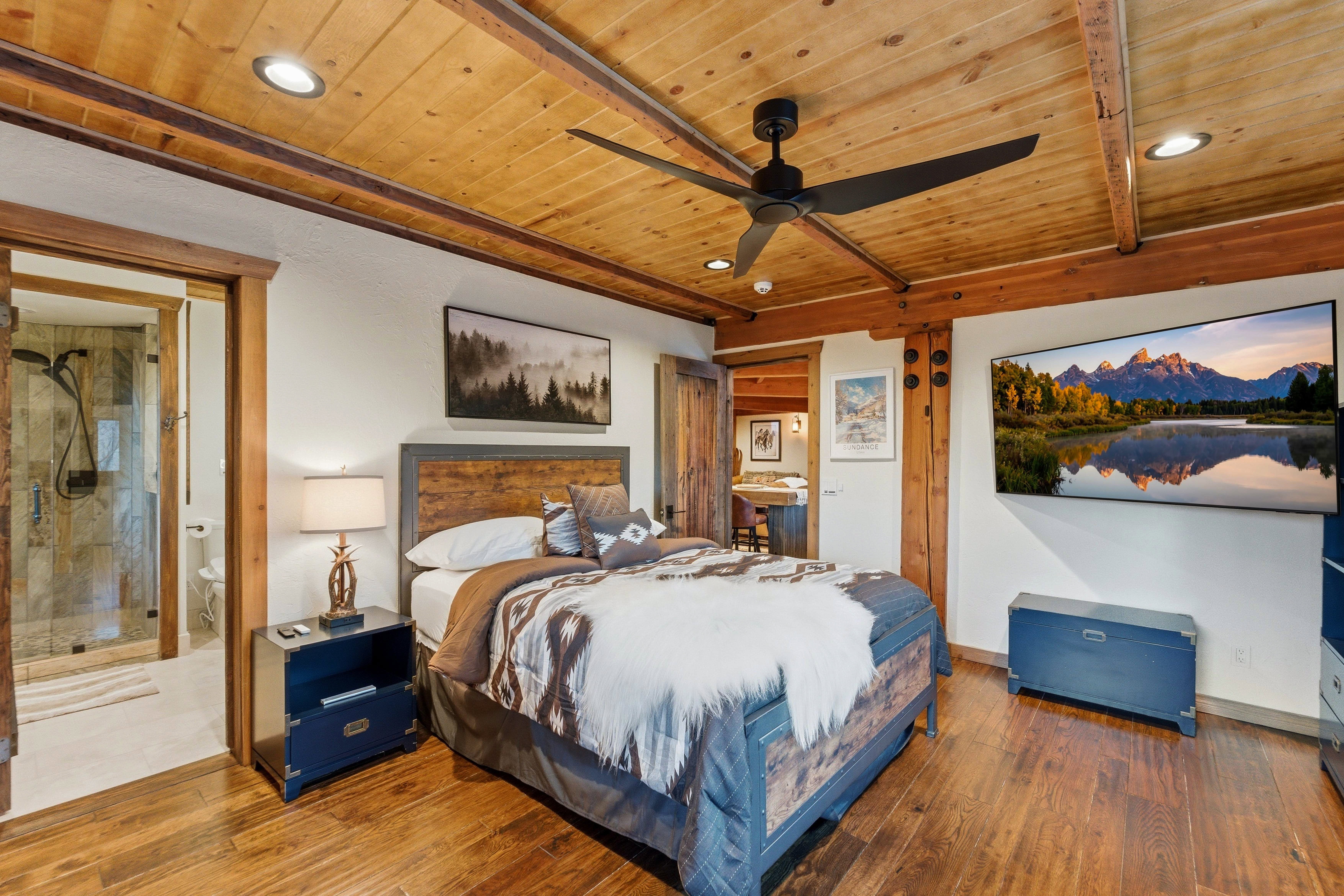 Bedroom with recessed lighting, a wooden ceiling with exposed beams, a ceiling fan, wood-type flooring, and connected bathroom