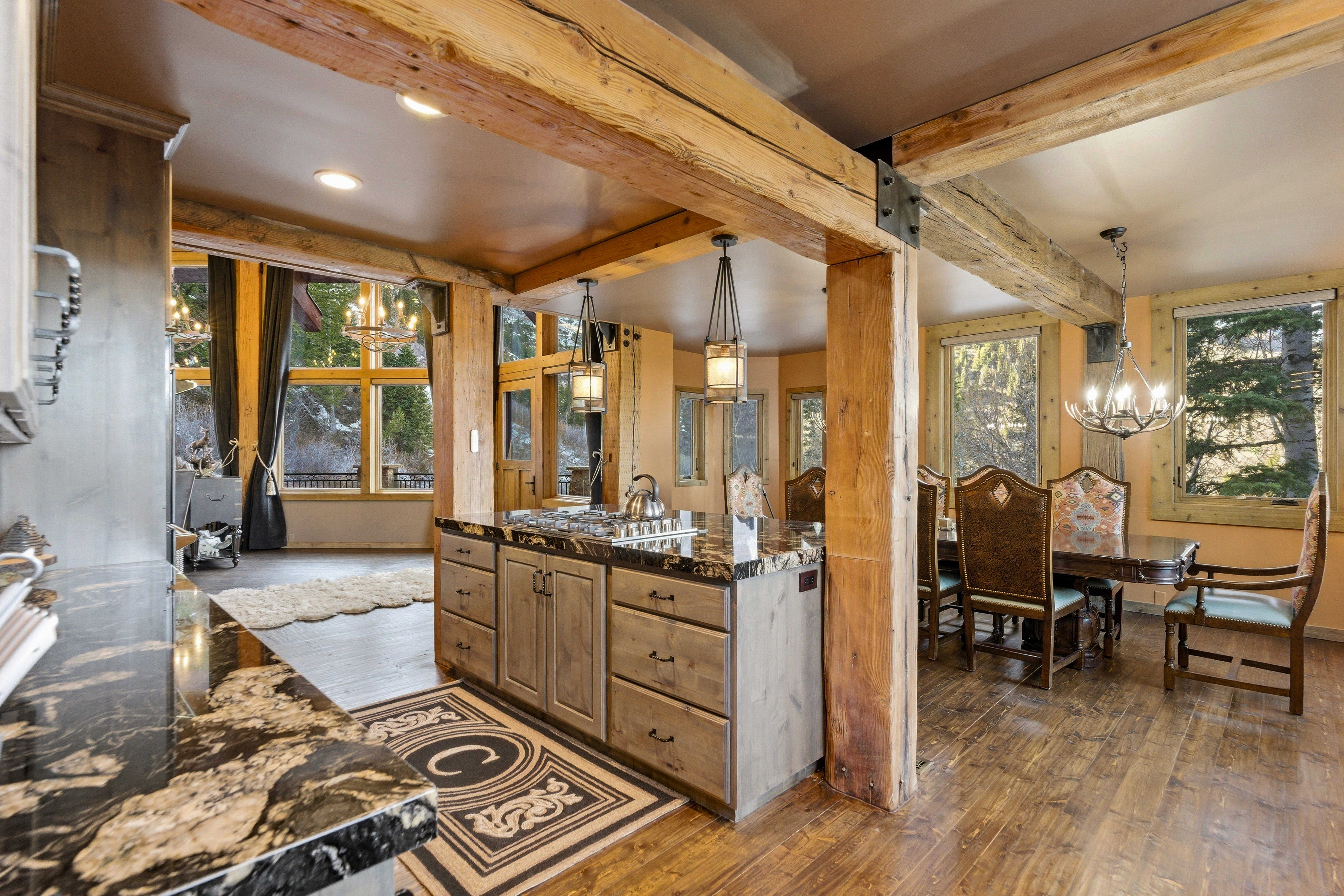 Full bathroom with hanging lights, vanity, dark wood-type flooring, healthy amount of natural light, and beam ceiling